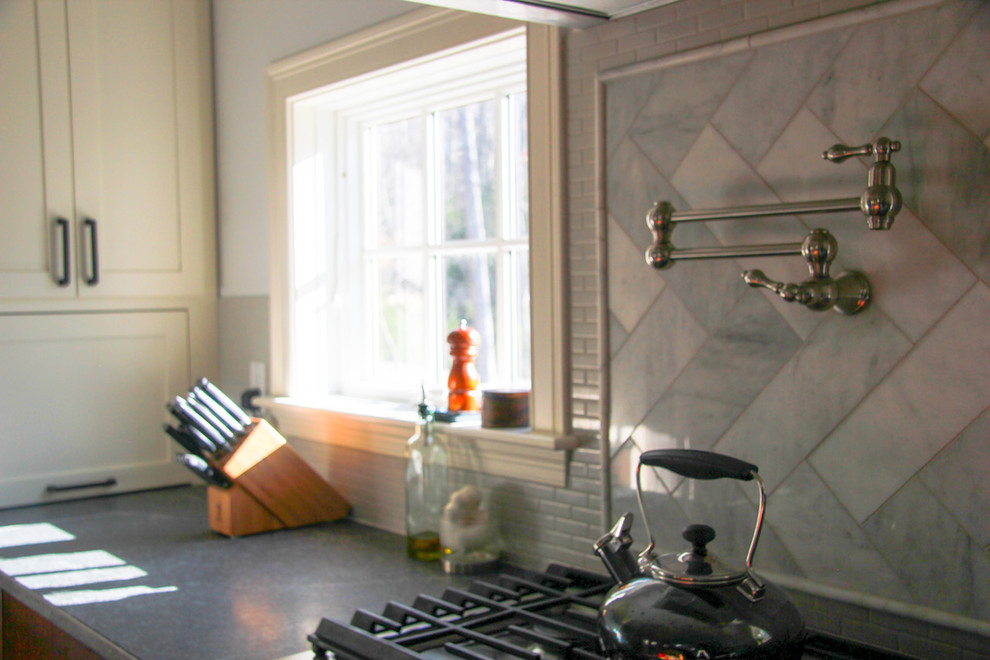 Example of a large transitional u-shaped eat-in kitchen design in Boston with an undermount sink, shaker cabinets, dark wood cabinets, granite countertops, gray backsplash, ceramic backsplash, stainless steel appliances and a peninsula