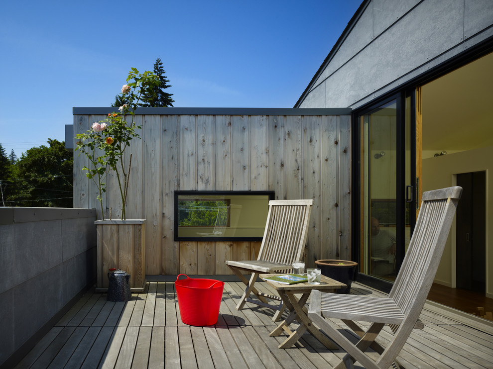 Photo of a small modern rooftop and first floor deck in Seattle with a container garden and no cover.
