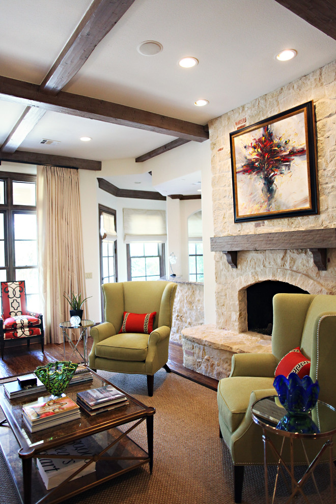 Traditional living room in Dallas with dark hardwood floors, a standard fireplace and a stone fireplace surround.