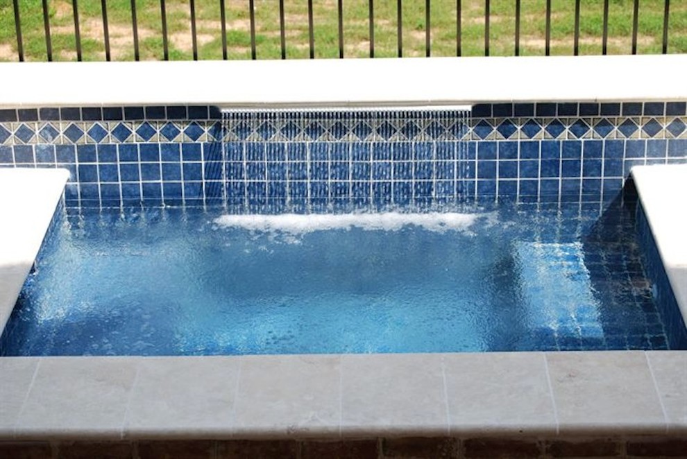 Pool fountain - mid-sized backyard stone and rectangular natural pool fountain idea
