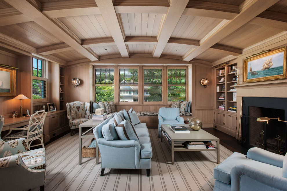 This is an example of a medium sized beach style home office in Seattle with a reading nook, medium hardwood flooring, a standard fireplace, a stone fireplace surround, a built-in desk, brown floors, a coffered ceiling, panelled walls and a chimney breast.