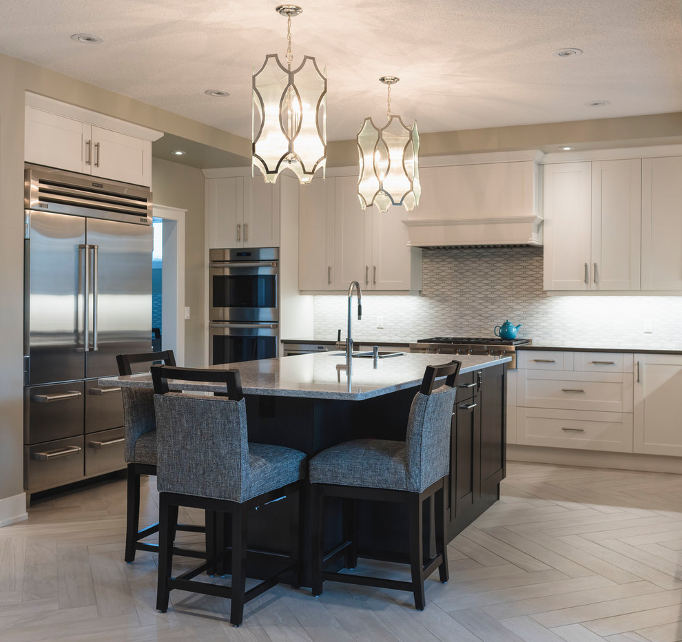 Example of a large transitional u-shaped porcelain tile and gray floor kitchen design in Edmonton with shaker cabinets, white cabinets, quartz countertops, white backsplash, marble backsplash, stainless steel appliances and an island