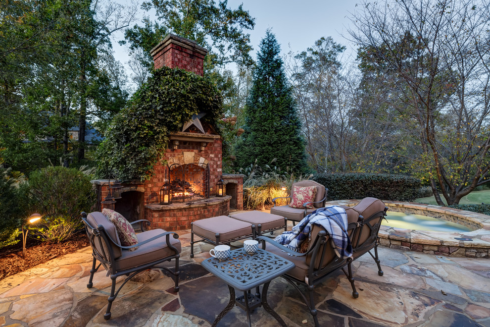 Design ideas for a traditional patio in Atlanta with a fire feature, natural stone pavers and no cover.