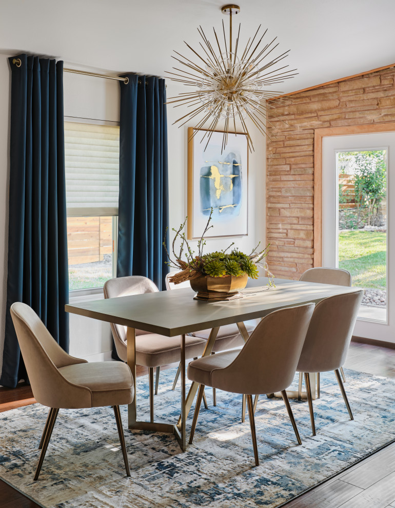 Mid-sized midcentury open plan dining in Austin with white walls, medium hardwood floors, brown floor, vaulted and brick walls.