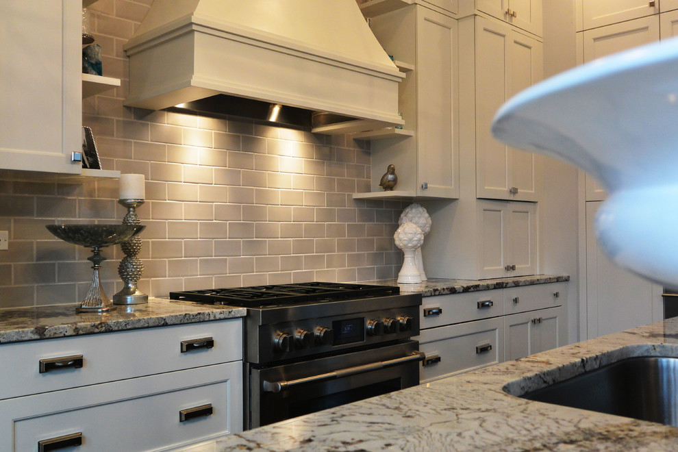 Inspiration for a transitional l-shaped eat-in kitchen remodel in Chicago with a single-bowl sink, recessed-panel cabinets, white cabinets, quartzite countertops, gray backsplash, subway tile backsplash and stainless steel appliances
