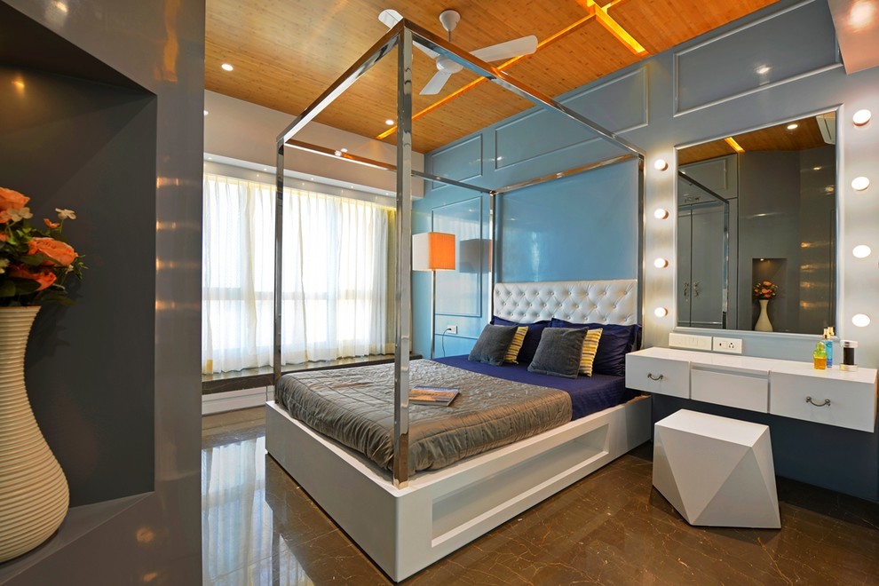 This is an example of an eclectic master bedroom in Mumbai with blue walls.