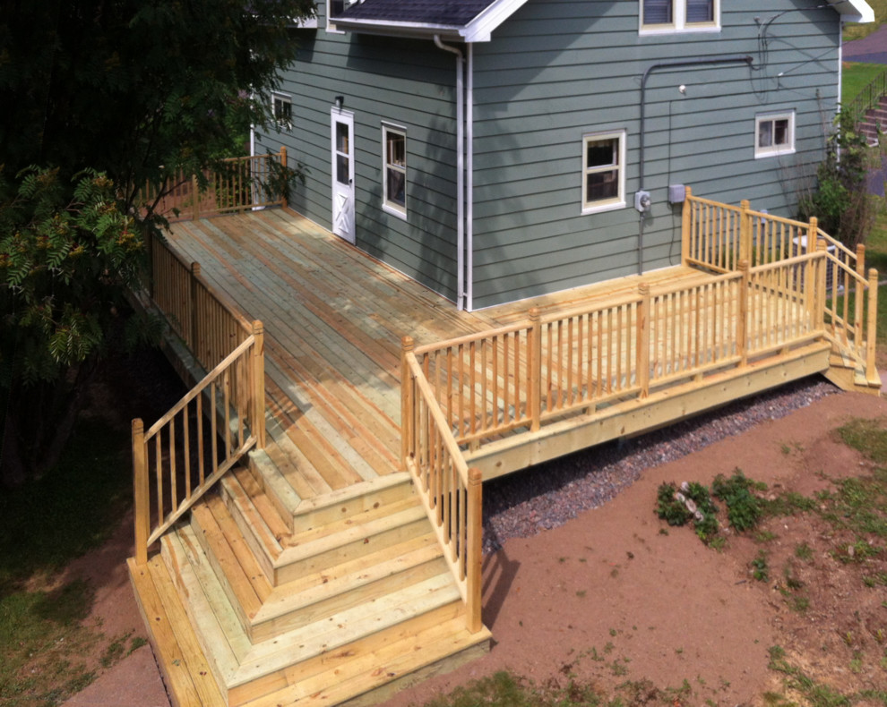 Mid-sized traditional backyard deck in Other with no cover.
