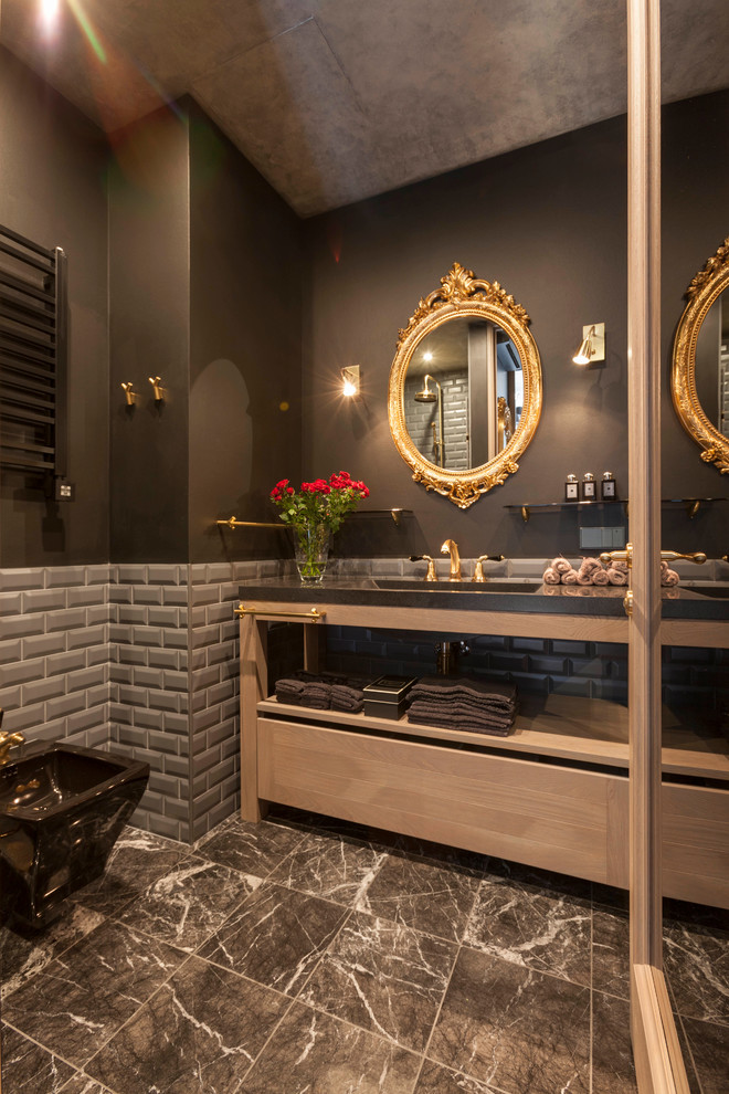 This is an example of an eclectic bathroom in Saint Petersburg with gray tile, subway tile, brown walls and an integrated sink.