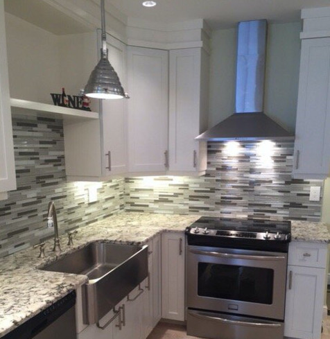 Inspiration for a transitional kitchen remodel in Miami with shaker cabinets, white cabinets, granite countertops, multicolored backsplash, matchstick tile backsplash and stainless steel appliances
