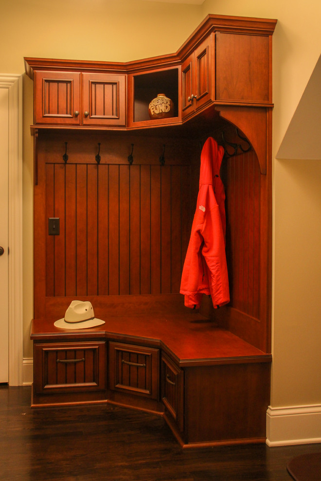 This is an example of a traditional mudroom in Chicago with beige walls, dark hardwood floors, a single front door and a white front door.