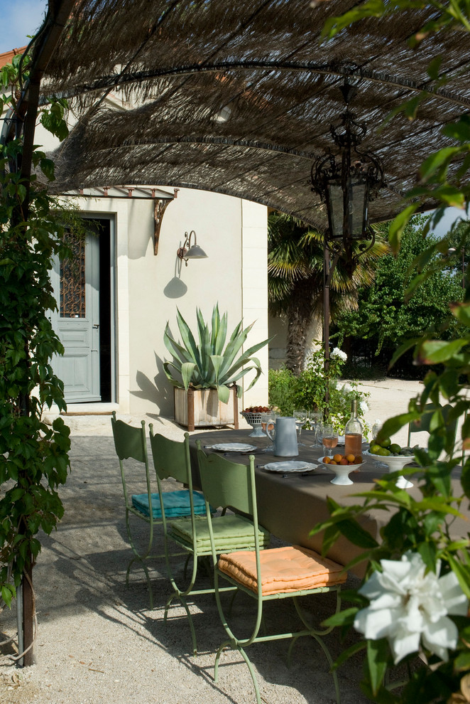 Large mediterranean backyard patio in Nice with a pergola and a container garden.