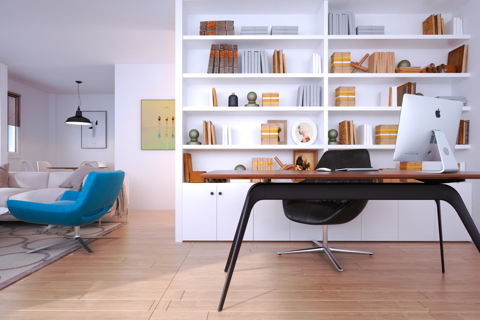 Photo of a modern home office in Paris with a library and light hardwood floors.