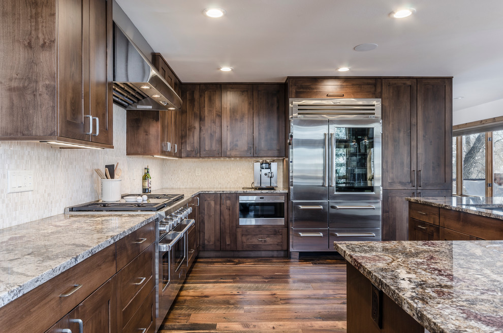 Kitchen pantry - large transitional l-shaped kitchen pantry idea in Denver with flat-panel cabinets, dark wood cabinets and an island