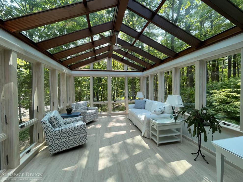 This is an example of a mid-sized traditional sunroom in Portland Maine with ceramic floors, no fireplace, a glass ceiling and grey floor.