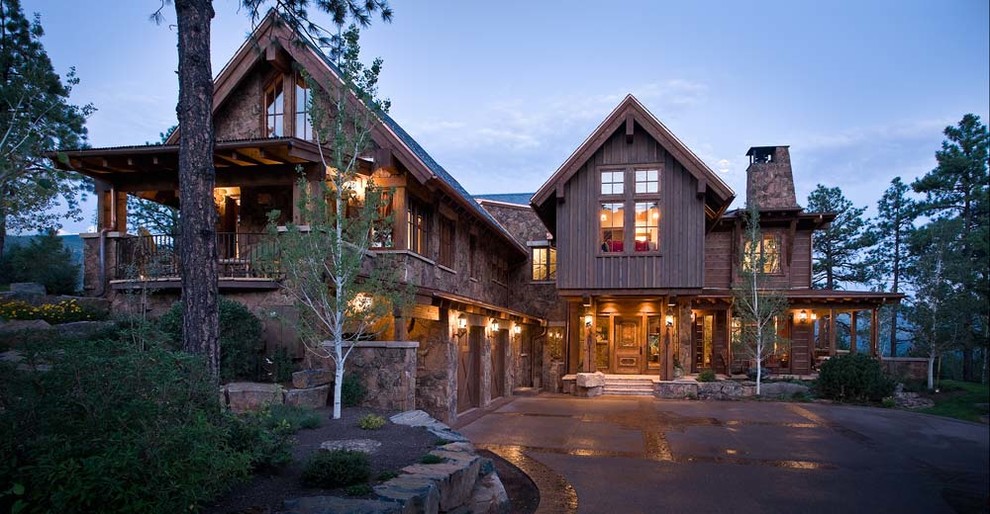 Inspiration for a modern two-storey brown exterior in Albuquerque with stone veneer and a gable roof.