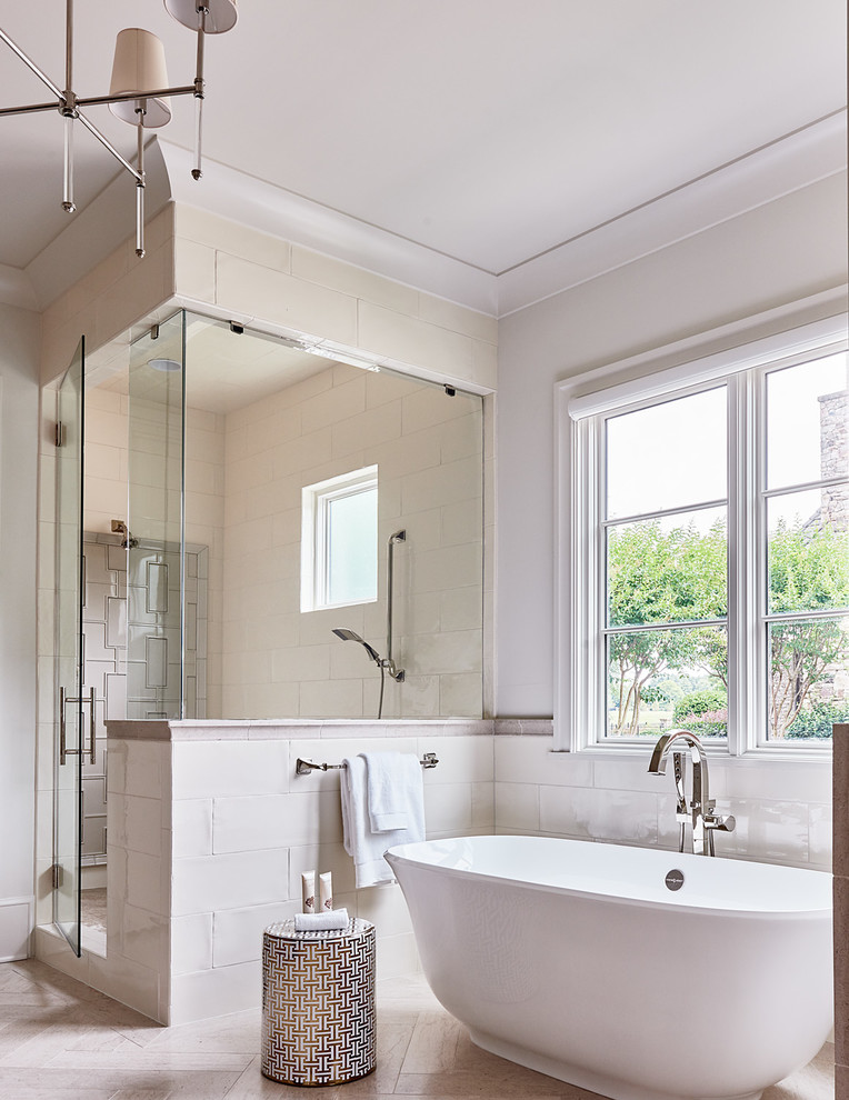 Large transitional master beige tile and porcelain tile ceramic tile and beige floor freestanding bathtub photo in Charlotte with a one-piece toilet, beige walls, a vessel sink and a hinged shower door