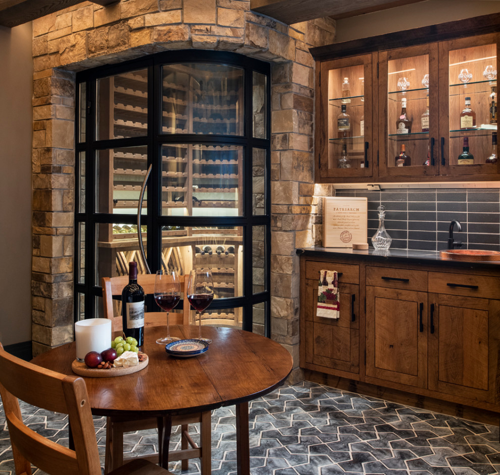 Inspiration for a large arts and crafts wine cellar in Denver with terra-cotta floors, display racks and black floor.