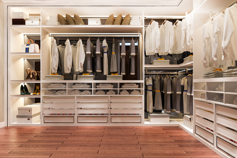 Inspiration for a large modern gender-neutral walk-in wardrobe in Vancouver with open cabinets, white cabinets, laminate floors and brown floor.