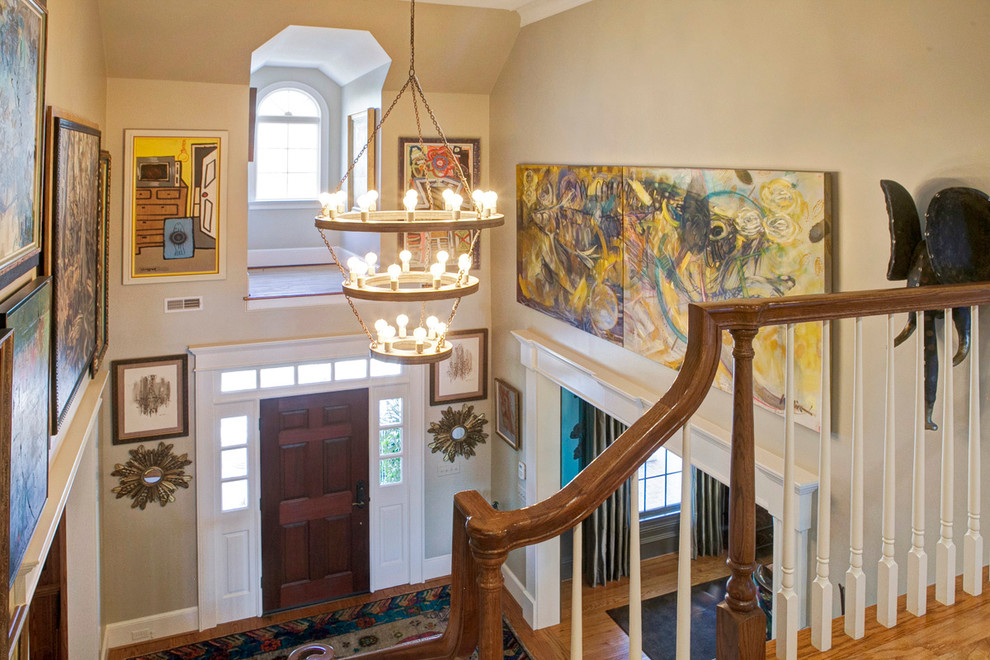 Photo of a large eclectic foyer in Other with beige walls, medium hardwood floors, a single front door and a dark wood front door.
