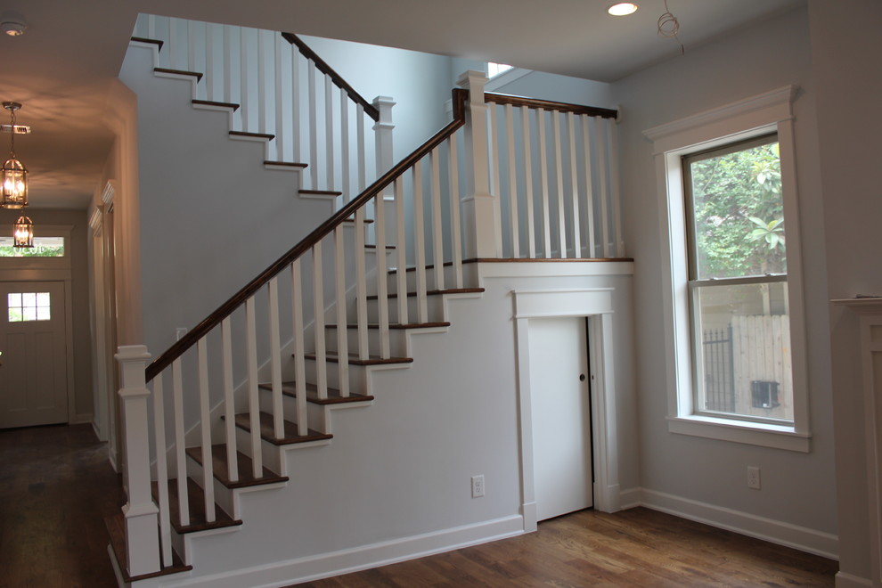 Mid-sized transitional wood u-shaped staircase in Houston with wood risers.