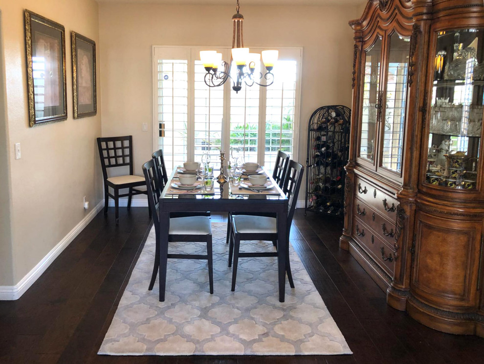 Inspiration for a mid-sized transitional separate dining room in Los Angeles with beige walls, dark hardwood floors, no fireplace and brown floor.