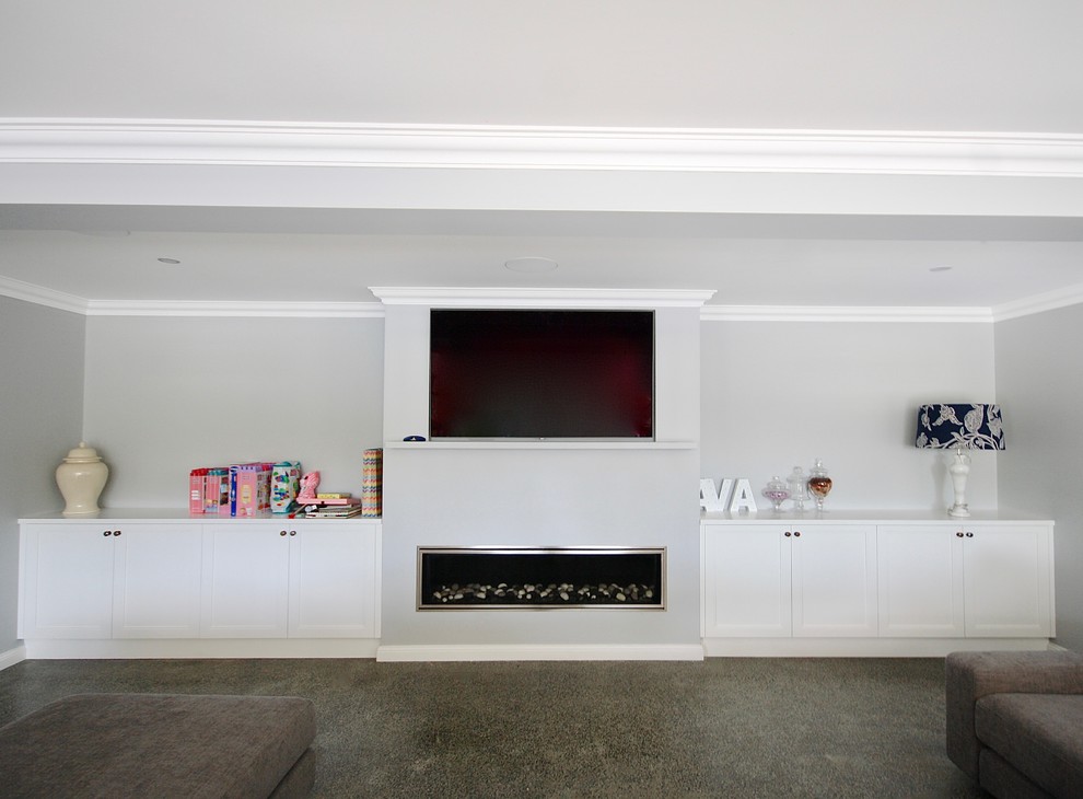Inspiration for a large transitional open concept home theatre in Sydney with white walls, concrete floors, a built-in media wall and grey floor.