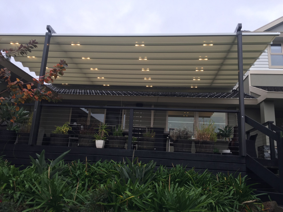 Photo of a large country courtyard deck in Melbourne with a pergola.