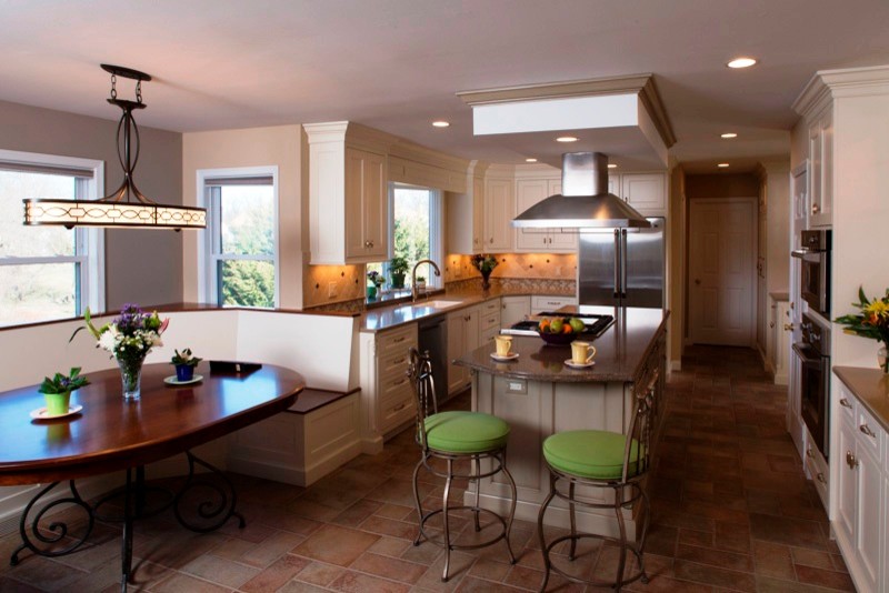 Inspiration for a transitional u-shaped porcelain tile kitchen pantry remodel with beaded inset cabinets, quartz countertops, an island, stone tile backsplash, stainless steel appliances and an undermount sink