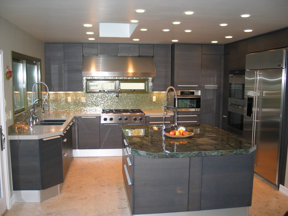 This is an example of a large contemporary u-shaped eat-in kitchen in San Diego with a double-bowl sink, flat-panel cabinets, grey cabinets, granite benchtops, green splashback, glass tile splashback, stainless steel appliances, travertine floors and with island.