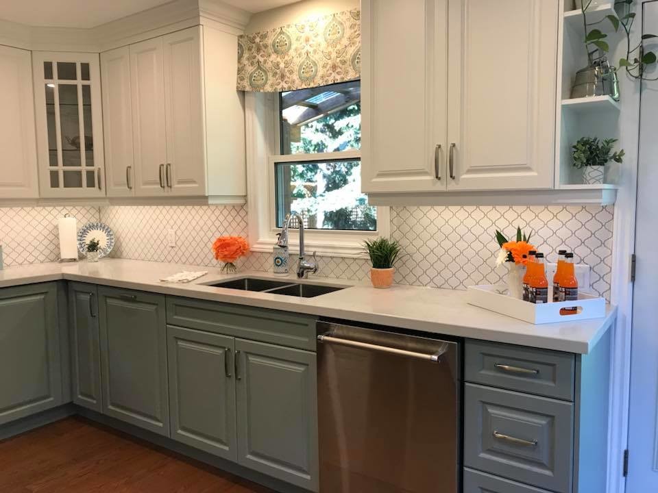 Inspiration for a transitional u-shaped medium tone wood floor eat-in kitchen remodel in Toronto with an undermount sink, raised-panel cabinets, white cabinets, quartz countertops, white backsplash, porcelain backsplash, stainless steel appliances, no island and white countertops