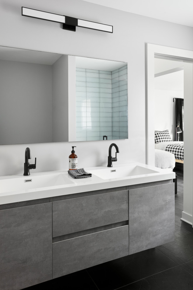 "Camp" Cabin Project - Inspiration for a rustic kids' black floor and double-sink bathroom remodel in Chicago with flat-panel cabinets, gray cabinets, gray walls, an integrated sink, white countertops and a floating vanity