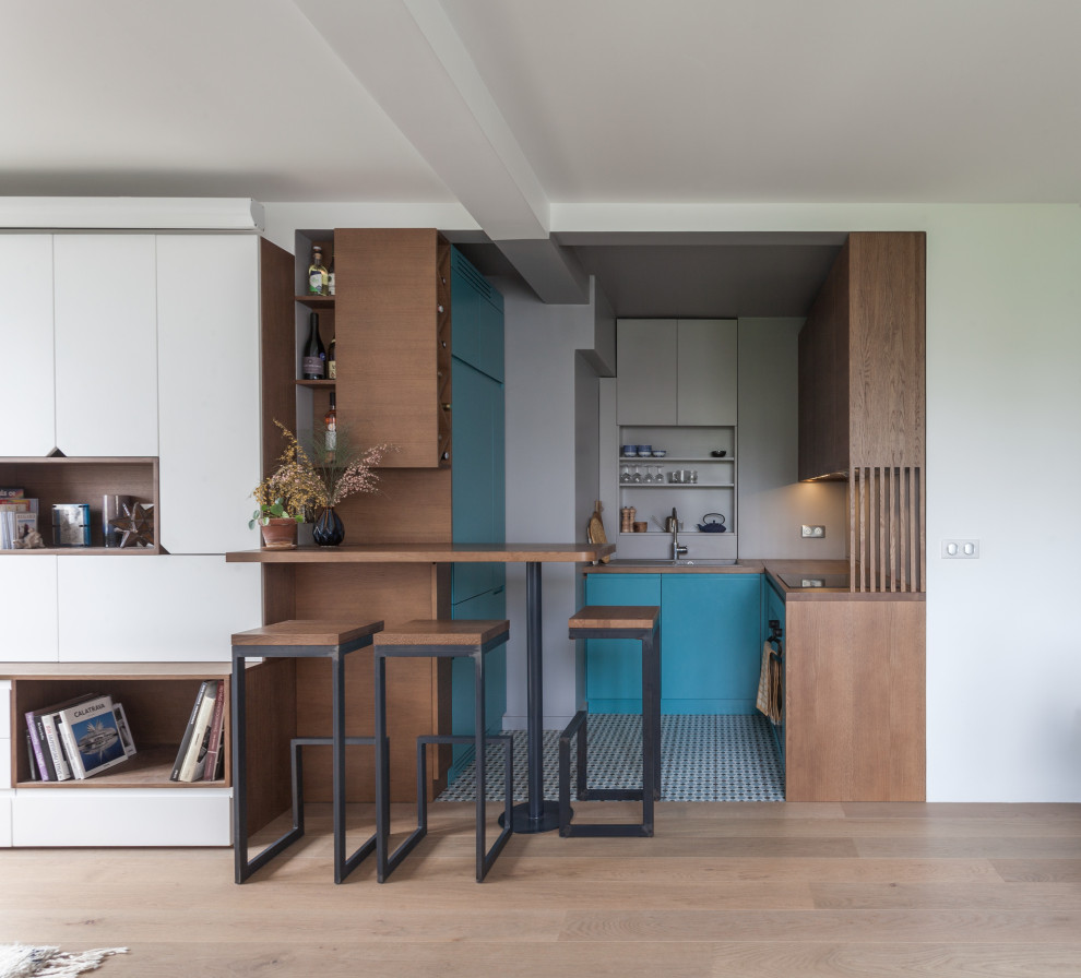 Design ideas for a small contemporary u-shaped eat-in kitchen in Paris with an integrated sink, beaded inset cabinets, wood benchtops, grey splashback, panelled appliances, ceramic floors, no island, multi-coloured floor and dark wood cabinets.