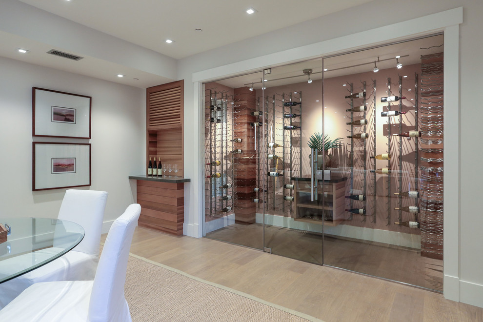 Inspiration for a large contemporary wine cellar in San Francisco with light hardwood floors, display racks and grey floor.