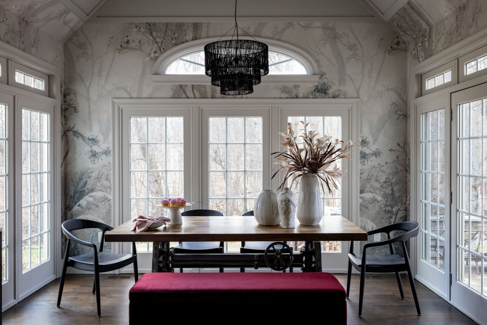 Example of a transitional dark wood floor, brown floor and wallpaper dining room design in Boston with multicolored walls