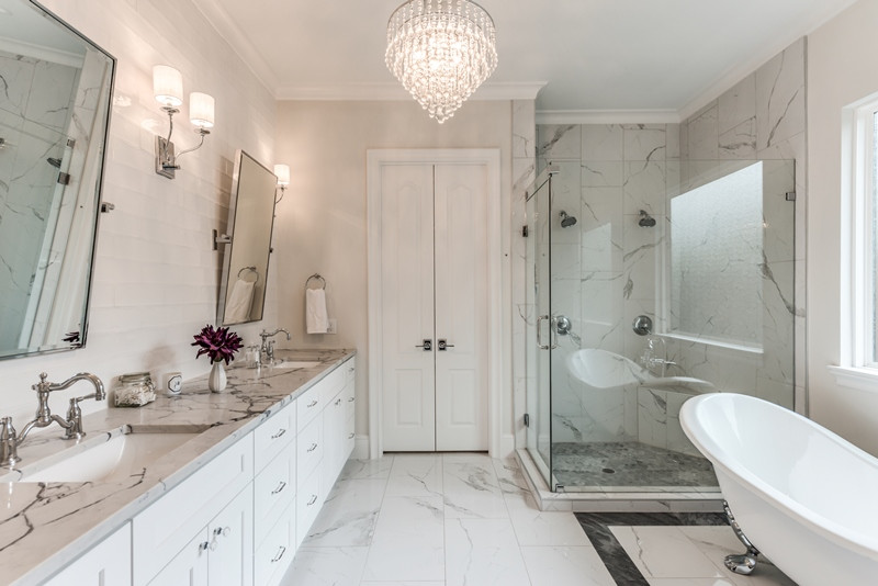 Inspiration for a large country master bathroom in Houston with shaker cabinets, white cabinets, a claw-foot tub, a corner shower, white tile, porcelain tile, white walls, porcelain floors, an undermount sink, engineered quartz benchtops, white floor, a hinged shower door and white benchtops.