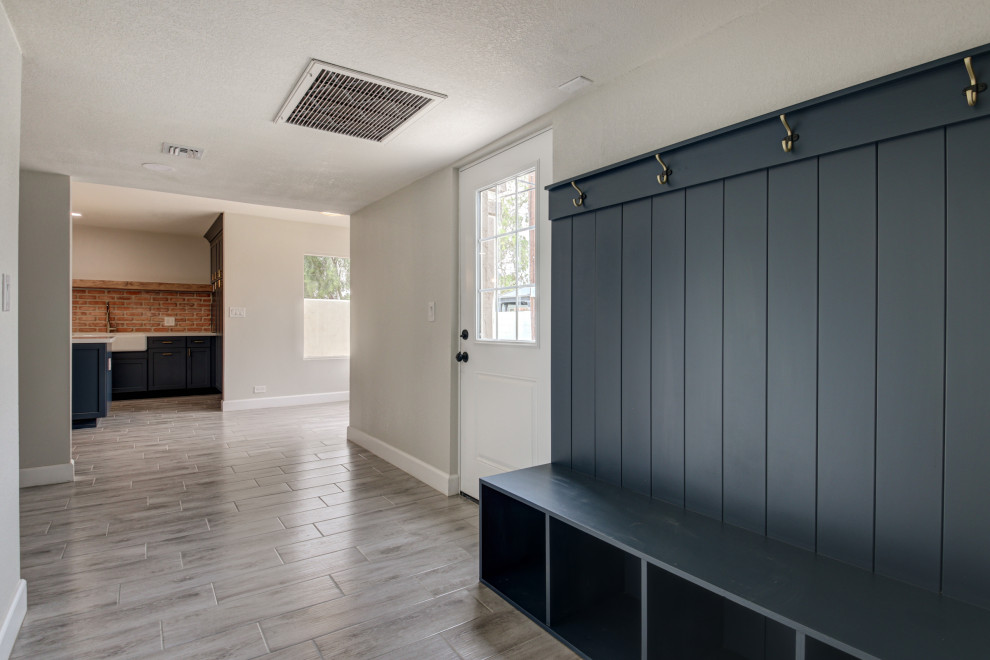 Inspiration for a mid-sized transitional porcelain tile and gray floor entryway remodel in Phoenix