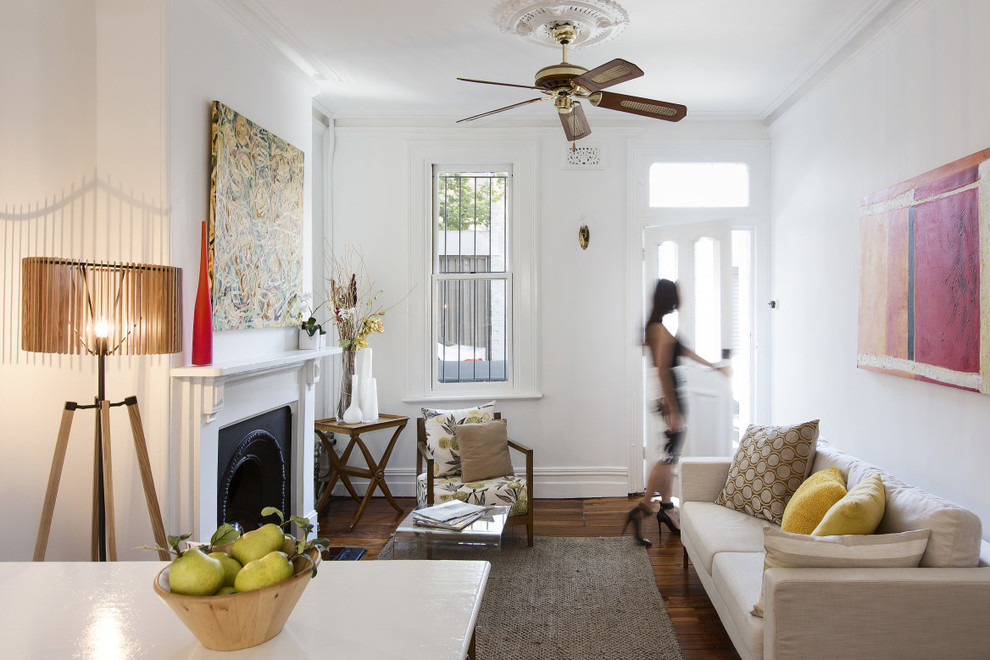 Photo of a small eclectic formal open concept living room in Sydney with white walls, a standard fireplace and no tv.