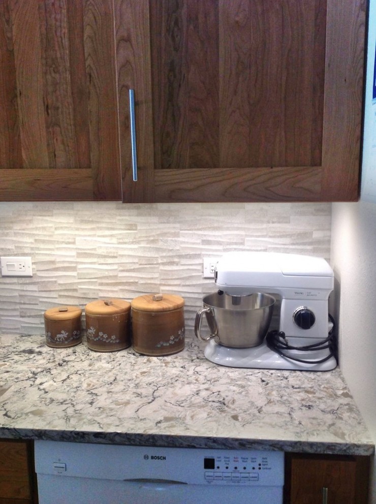 Mid-sized transitional u-shaped medium tone wood floor enclosed kitchen photo with an undermount sink, shaker cabinets, dark wood cabinets, granite countertops, gray backsplash, stone tile backsplash, white appliances and no island