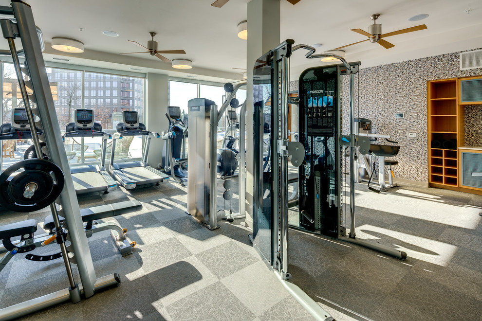 Photo of a large modern multipurpose gym in Minneapolis with multi-coloured walls, vinyl floors and grey floor.