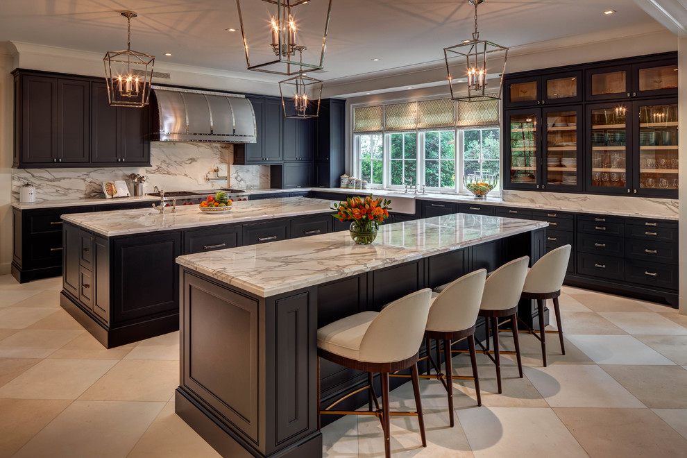 Photo of a transitional l-shaped separate kitchen in Houston with a farmhouse sink, glass-front cabinets, dark wood cabinets, marble benchtops, white splashback, stainless steel appliances, ceramic floors and multiple islands.
