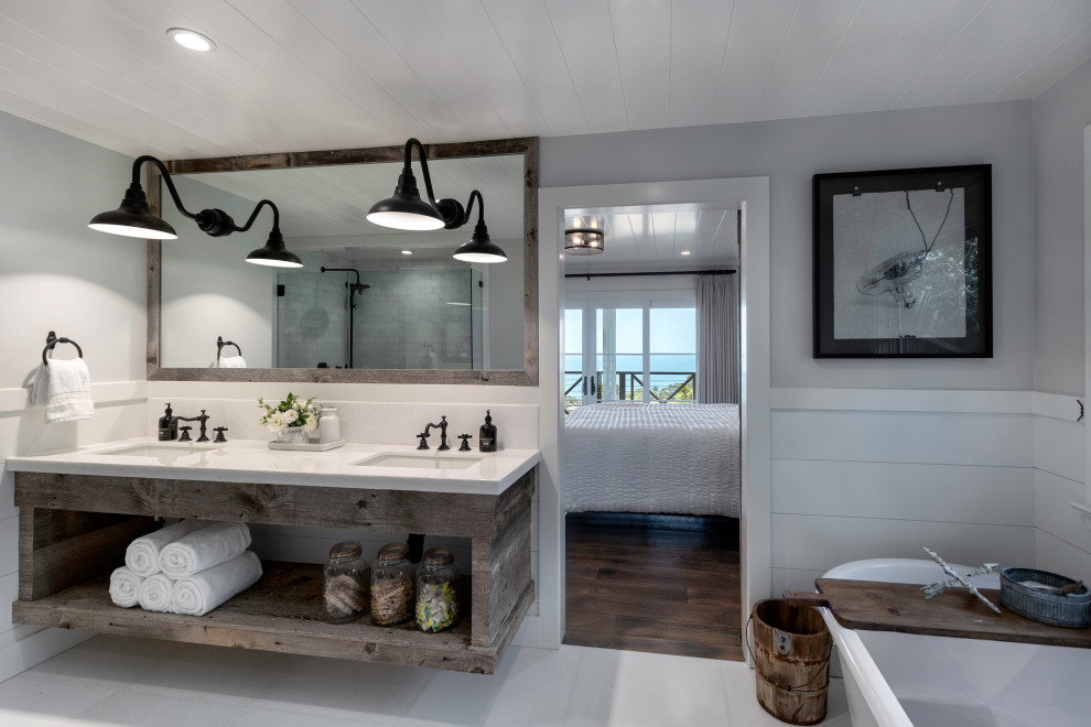 This is an example of a large country master bathroom in Orange County with open cabinets, grey cabinets, a freestanding tub, white tile, marble, white walls, marble floors, an undermount sink, marble benchtops, white floor and white benchtops.