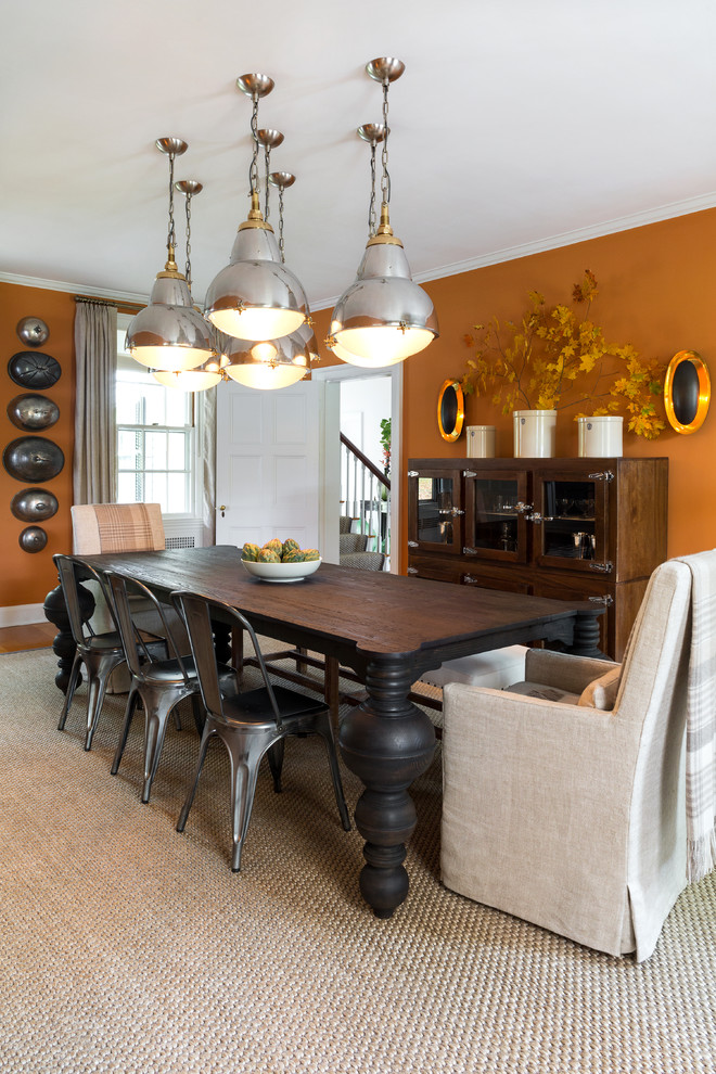 Inspiration for a large transitional separate dining room in Bridgeport with orange walls, medium hardwood floors, a standard fireplace and a stone fireplace surround.