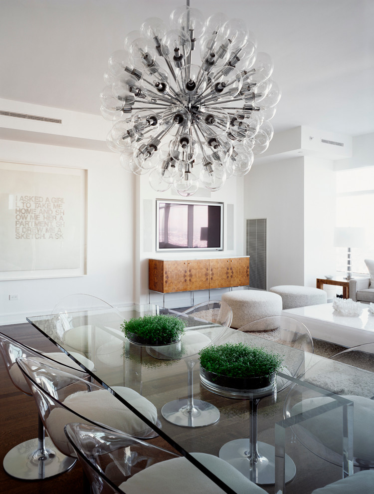 This is an example of a contemporary dining room in New York with white walls.