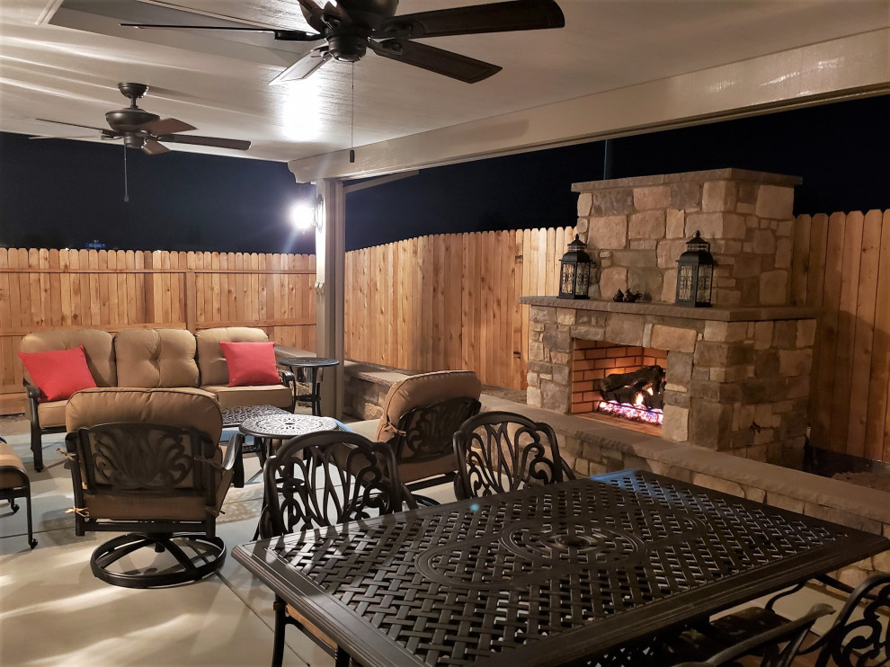 Photo of a mid-sized arts and crafts backyard patio in Other with with fireplace, concrete slab and a pergola.