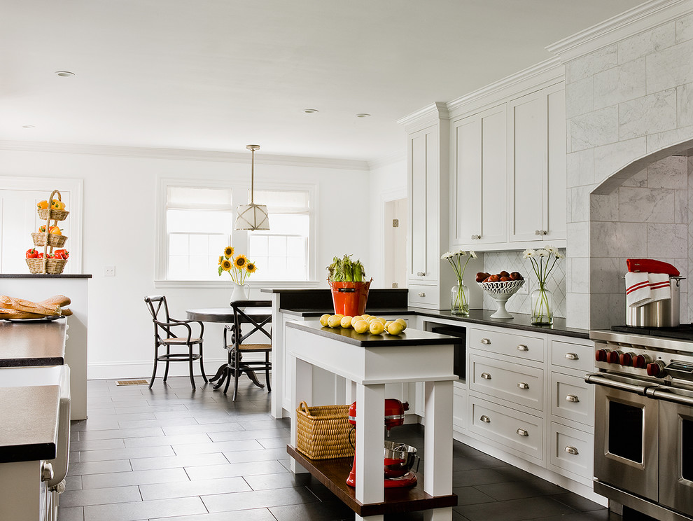 Inspiration for a traditional eat-in kitchen in Boston with shaker cabinets, stainless steel appliances, with island, white splashback and ceramic floors.