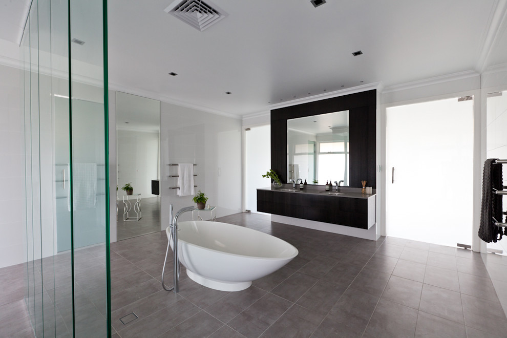 Inspiration for an expansive contemporary master bathroom in Perth with an undermount sink, flat-panel cabinets, brown cabinets, engineered quartz benchtops, a freestanding tub, an open shower, gray tile, ceramic tile, white walls and ceramic floors.