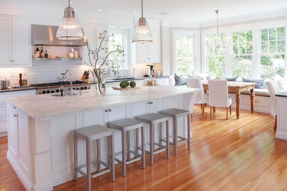 Inspiration for a traditional eat-in kitchen in New York with subway tile splashback, marble benchtops, recessed-panel cabinets, white cabinets, white splashback and white benchtop.