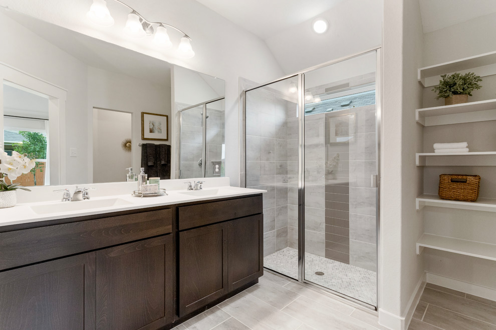 Design ideas for a mid-sized contemporary master bathroom in Other with recessed-panel cabinets, brown cabinets, an alcove shower, beige tile, ceramic tile, white walls, ceramic floors, an integrated sink, solid surface benchtops, beige floor, a hinged shower door and white benchtops.