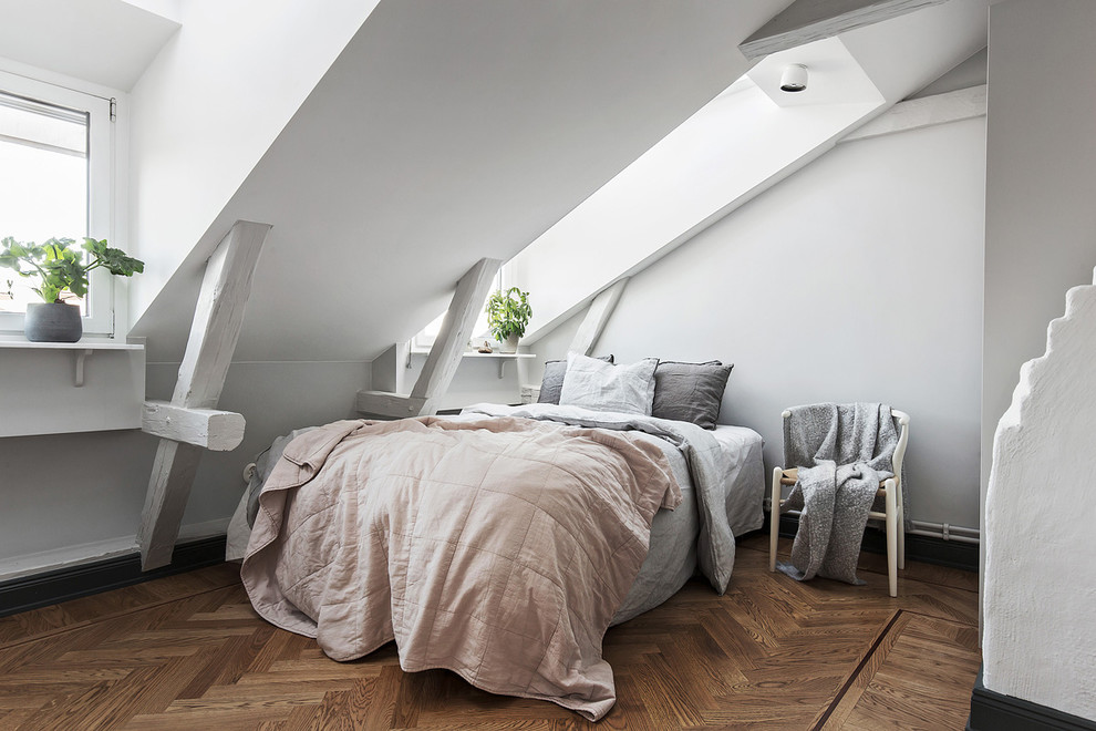 Mid-sized scandinavian guest bedroom in Stockholm with grey walls, medium hardwood floors and no fireplace.