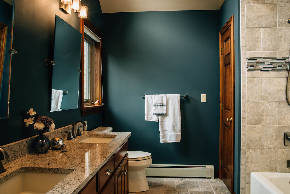 Alcove bathtub - mid-sized transitional master beige tile and travertine tile travertine floor and beige floor alcove bathtub idea with raised-panel cabinets, dark wood cabinets, green walls, an undermount sink, granite countertops and gray countertops
